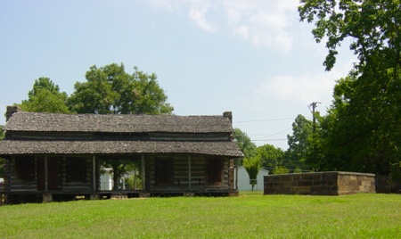 log cabin and gravesite